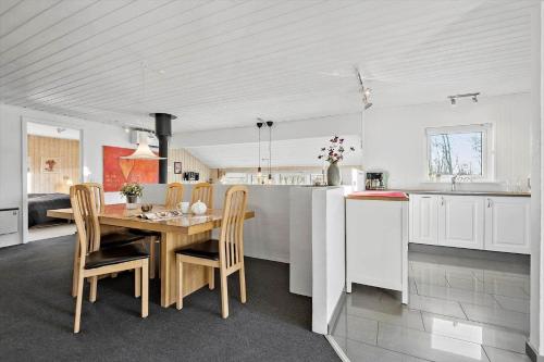 a kitchen and dining room with a wooden table and chairs at FAN056-Fano-Vesterengen-6 in Fanø