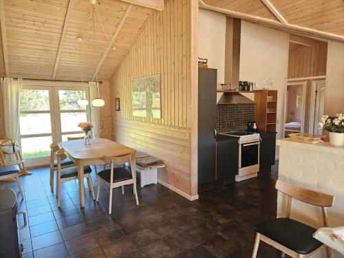 a kitchen and dining room with a table and chairs at FAN057-Fano-Sonder-Nytoft-4 in Fanø