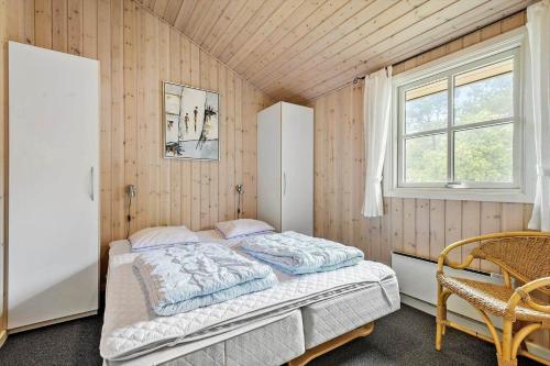 a bedroom with a bed and a window at FAN057-Fano-Sonder-Nytoft-4 in Fanø