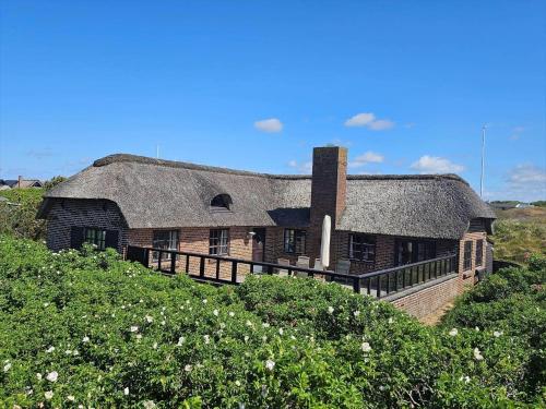 an old house with a thatched roof in a field at FAN068-Fano-Dalen-10 in Fanø