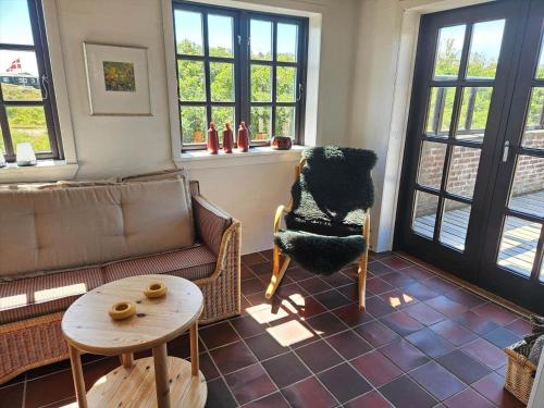 a living room with a couch and a table at FAN068-Fano-Dalen-10 in Fanø