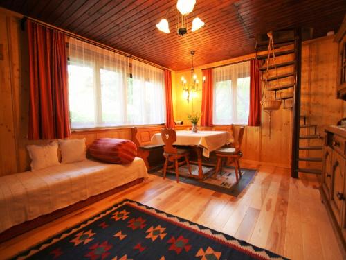 a bedroom with a bed and a table in a room at Chalet Nassfeld nahe Skipisten in Sonnenalpe Nassfeld