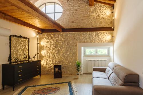 a living room with a couch and a window at Le Camere di Stefano - Spoleto in Spoleto