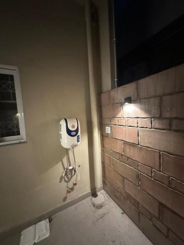 a bathroom with a soap dispenser on a wall at 2BR Modern Home in the heart of lahore New gardentown in Lahore