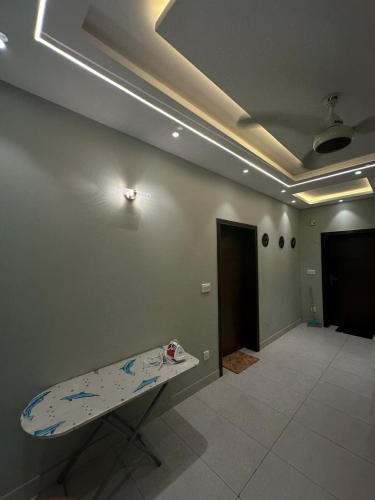 a room with a surfboard on the wall and a room with a door at 2BR Modern Home in the heart of lahore New gardentown in Lahore