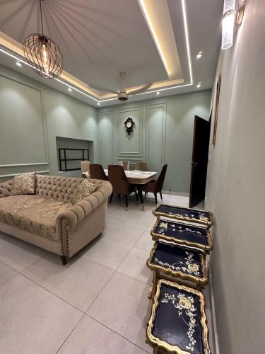 a living room with a couch and a table at 2BR Modern Home in the heart of lahore New gardentown in Lahore