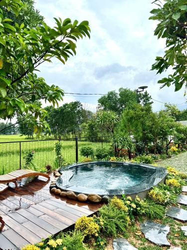 a hot tub in the middle of a garden at An House in Sóc Sơn