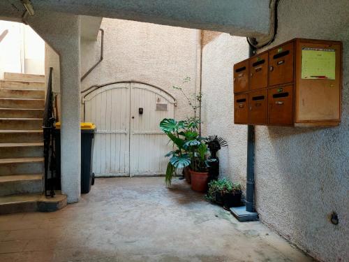 an entrance to a building with a door and some plants at AGDE Chambre d'Hôte in Agde