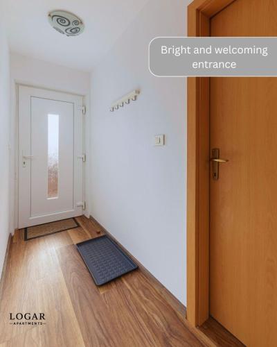 an empty room with a door and a mat on the floor at LOGAR Apartments in Preddvor