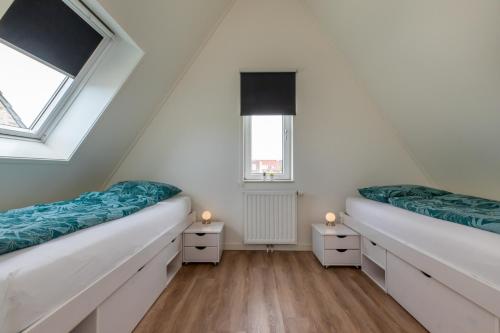 Postel nebo postele na pokoji v ubytování Vakantiehuis Zoutelande met grote tuin dichtbij strand