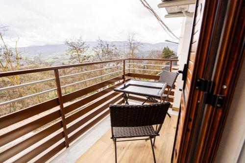 a balcony with two chairs and a table at Luna Gemella Suite & SPA in Calitri