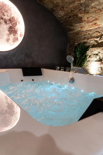 a bathroom with a bath tub with a water fountain at Luna Gemella Suite & SPA in Calitri