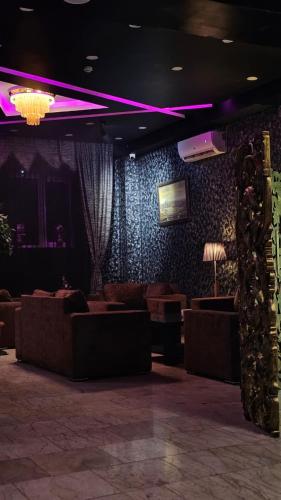 a living room with couches and purple lighting at City Hotel Baku in Baku