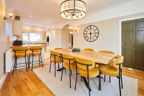 a kitchen and dining room with a wooden table and chairs at Host & Stay - Louvaine House in Witton Gilbert