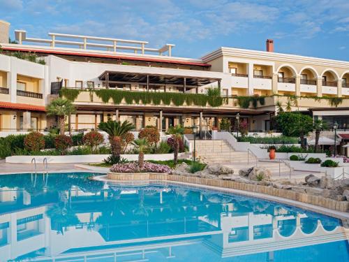 a hotel with a pool in front of a building at Aegean Melathron Thalasso Spa Hotel in Kallithea Halkidikis
