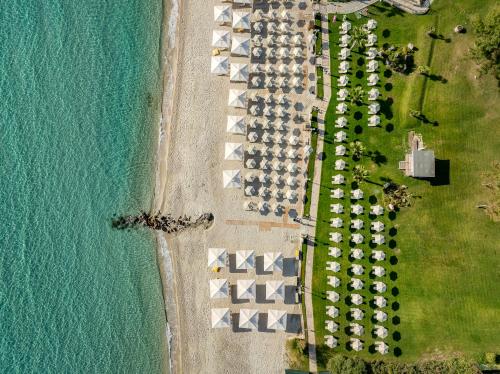 an aerial view of a row of parked cars next to the ocean at Aegean Melathron Thalasso Spa Hotel in Kallithea Halkidikis