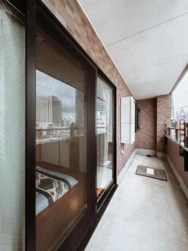 a room with large windows and a view of the city at Skytree STAR 11 Hotel in Tokyo