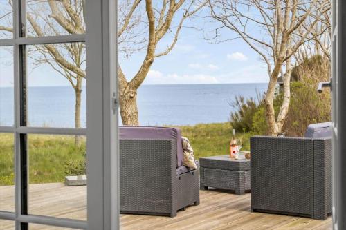a patio with a view of the ocean through a window at 8916-Allingabro-Borgmestervangen-16 in Allingåbro