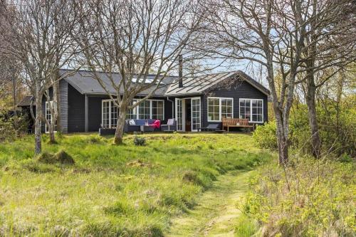 a black house in the middle of a field at 8916-Allingabro-Borgmestervangen-16 in Allingåbro