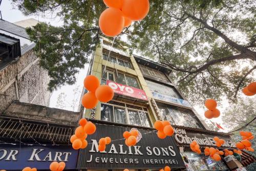 Hotel O POP A Happy Hours Plaza في نيودلهي: مجموعة من البالونات البرتقالية أمام مبنى