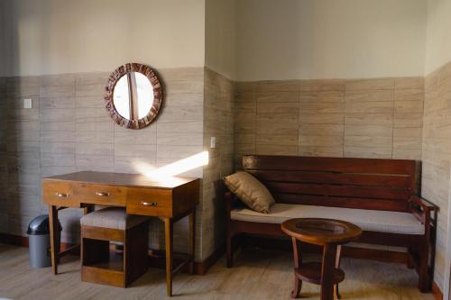 a room with a bench and a desk and a mirror at Bali Vanilli Villa in Sukawati