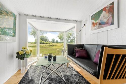 a living room with a couch and a table at 8517-Grenaa-Ellevej-31 in Grenå