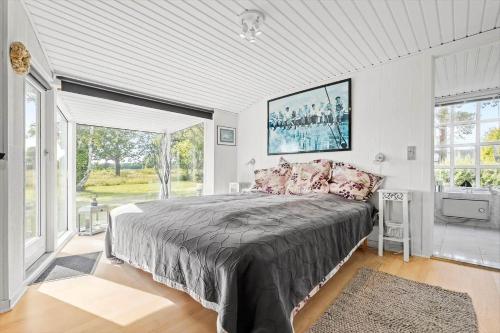 a bedroom with a large bed and a large window at 8517-Grenaa-Ellevej-31 in Grenå