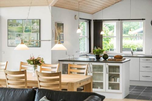 a kitchen and dining room with a table and chairs at 8920-Orsted-Ternevej-16 in Ørsted