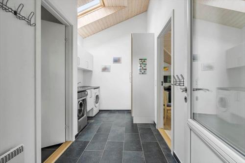 a kitchen with white walls and a tile floor at 8920-Orsted-Ternevej-16 in Ørsted