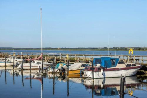 a group of boats are docked at a dock at 8920-Orsted-Ternevej-16 in Ørsted