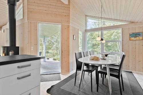 a kitchen and dining room with a table and chairs at 8995-Orsted-Alsikevej-9 in Ørsted