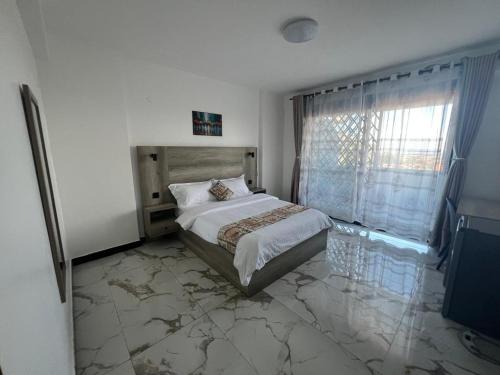 a bedroom with a bed with a marble floor at Three bedroom place with lake view in Kampala