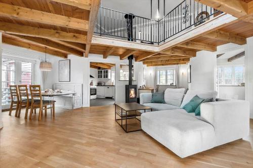 a living room with a white couch and a table at 8514-Grenaa-Sortebaervej-16 in Grenå