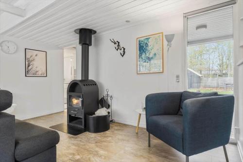 a living room with a fireplace and a couch at 8963-Orsted-Spovevej-6 in Ørsted