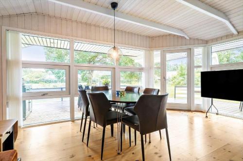 a dining room with a table and chairs at 8834-Glesborg-Hemming-Nielsens-Vej-11 in Glesborg