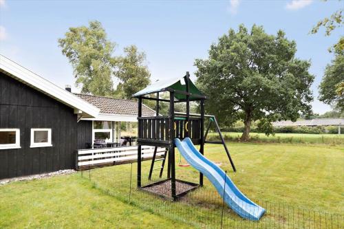 a playground with a slide in a yard at 8834-Glesborg-Hemming-Nielsens-Vej-11 in Glesborg