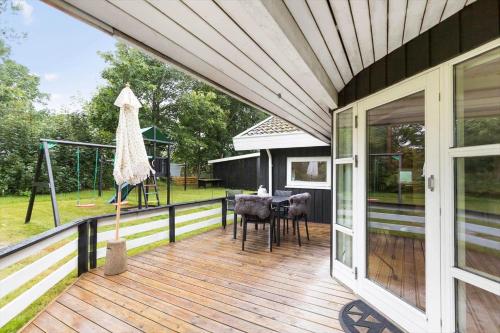 a porch of a house with a swing at 8834-Glesborg-Hemming-Nielsens-Vej-11 in Glesborg