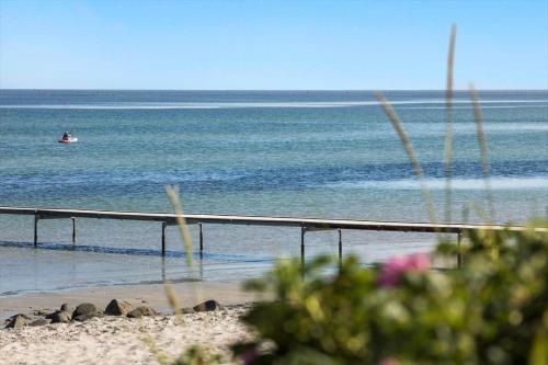 a person in a boat in the water on the beach at 8834-Glesborg-Hemming-Nielsens-Vej-11 in Glesborg