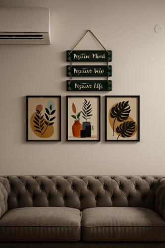 four pictures on a wall above a couch at 2BHK Luxury Villa In Mohali GF - Stay Royal in Mohali