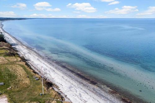 an aerial view of a beach and the ocean at 8924-Allingabro-Gyvelvej-26 in Allingåbro