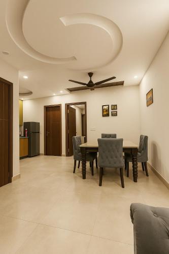 a dining room with a table and chairs and a ceiling at 2BHK Luxury Villa In Mohali GF - Stay Royal in Mohali
