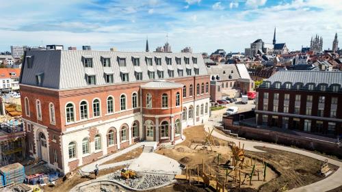 an aerial view of a large brick building in a city at Martin's Klooster in Leuven