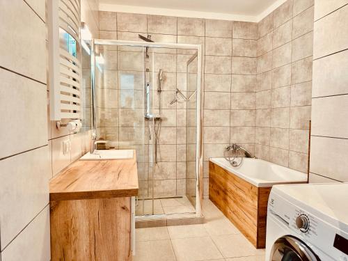 a bathroom with a shower and a sink at Baltic Inspiration - Guest Favorite, Excellent Location, 2 King Bedrooms, Jacuzzi Bath, Parking in Gdańsk
