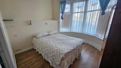 ein Schlafzimmer mit einem Bett und einem großen Fenster in der Unterkunft Park Road Guest House - Room To Rent On Park Road in Blackpool FY1 4ET in Blackpool