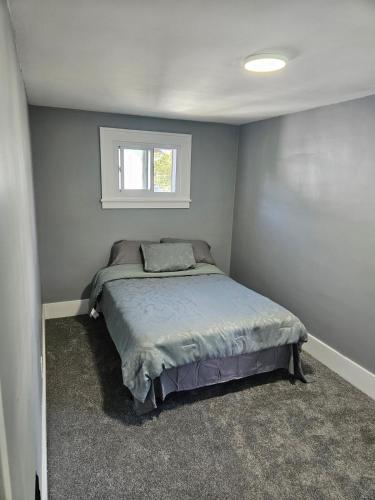 a bedroom with a bed and a window at Peace of Mind Loft in Rochester