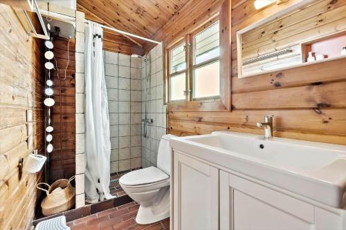 a bathroom with a white sink and a toilet at 84249-Knebel-Skraningen-13 in Knebel