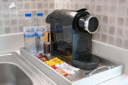 a coffee maker sitting on top of a sink at MarvelStay-Infinity Pool-Beachfront-The Palm in Dubai