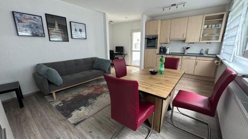a living room with a couch and a table and chairs at Beethoven Apartments in Solingen