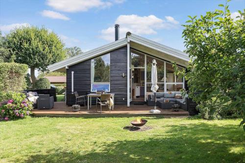 a small house with a deck in a yard at 1497-N-Gilleleje-Parcelvej-3 in Gilleleje