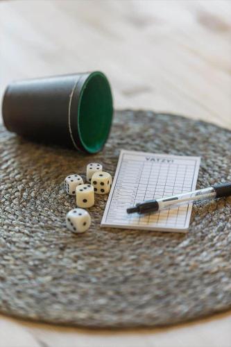 a pile of dice and a pen on a table at 1497-N-Gilleleje-Parcelvej-3 in Gilleleje